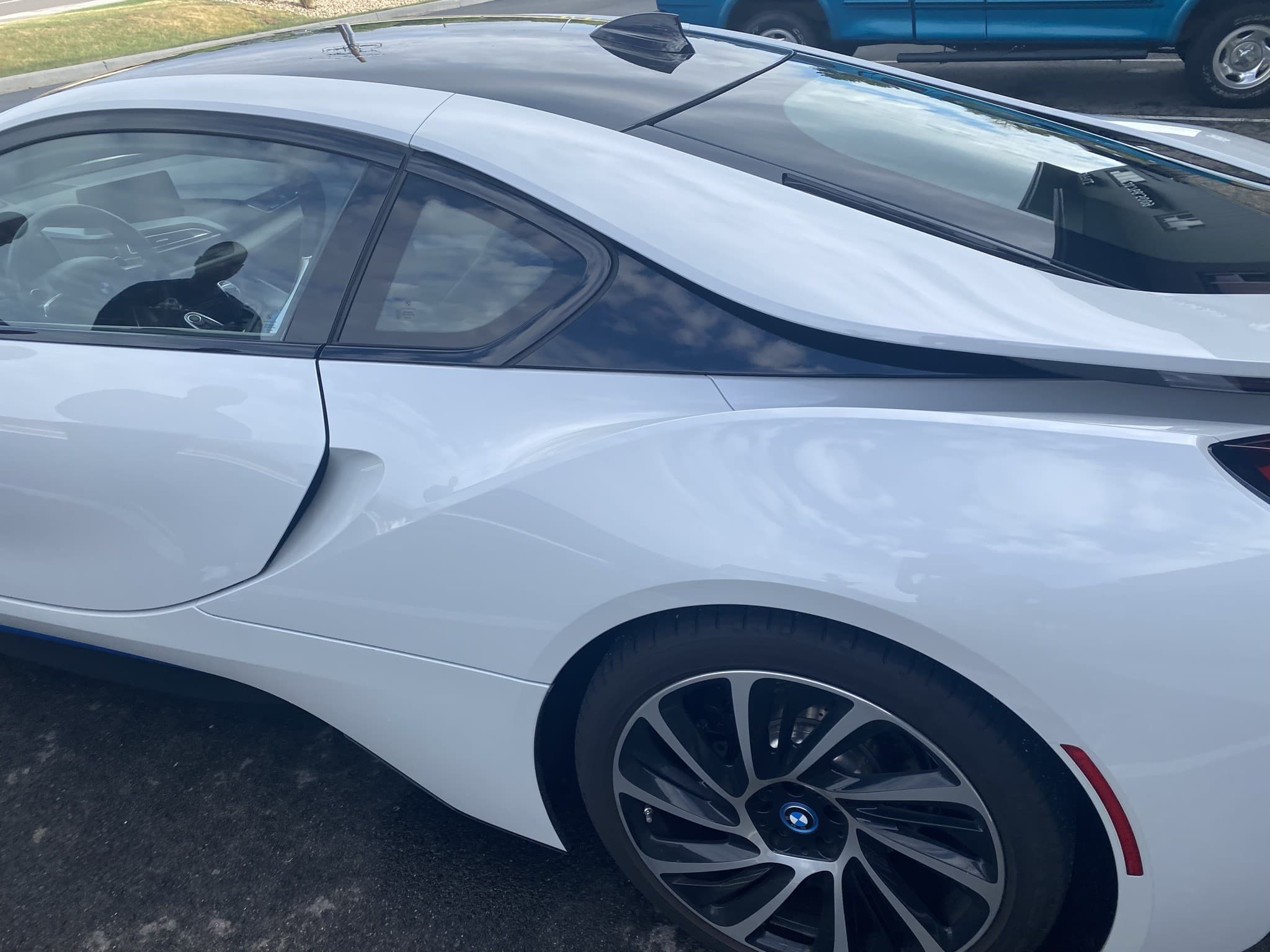 BMW i8 in white with blue accents, side profile