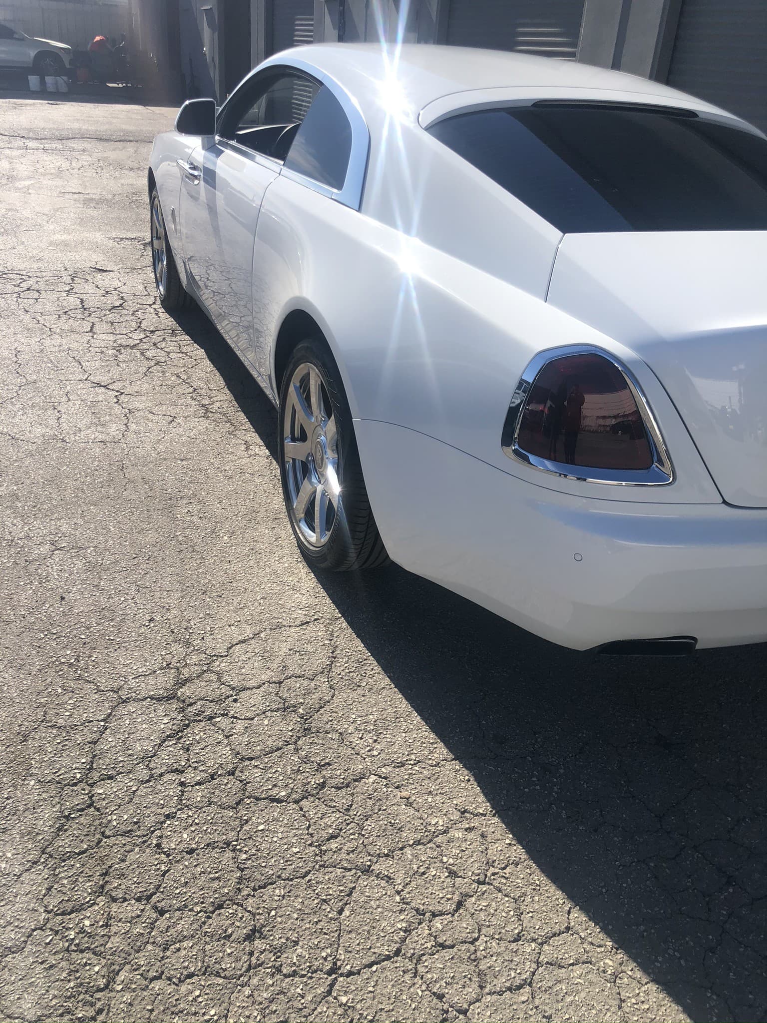 Rolls-Royce Wraith fastback coupe in white, outdoor side profile