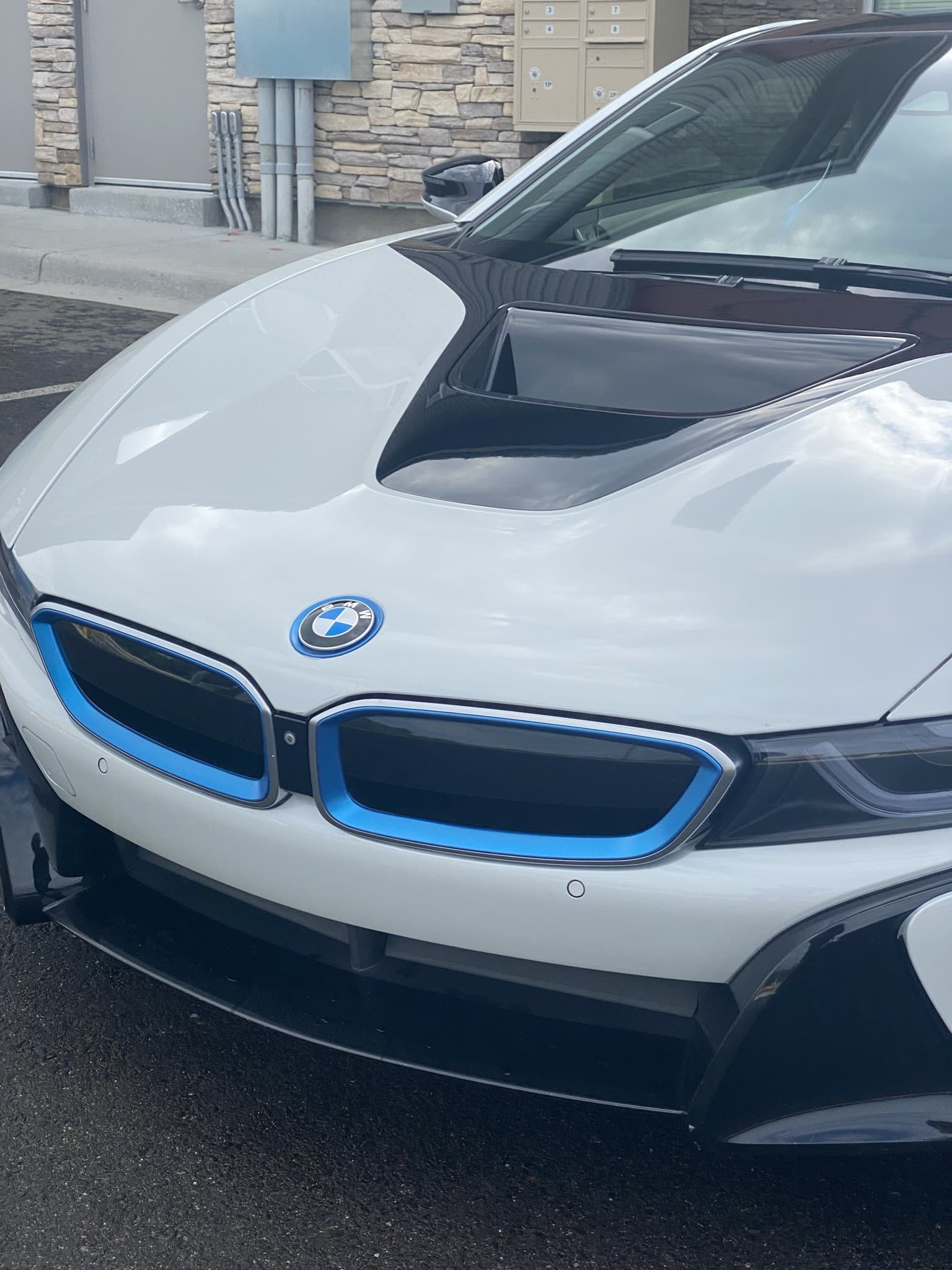 BMW i8 staged at a stone-clad Greenwich residence for a wedding pickup